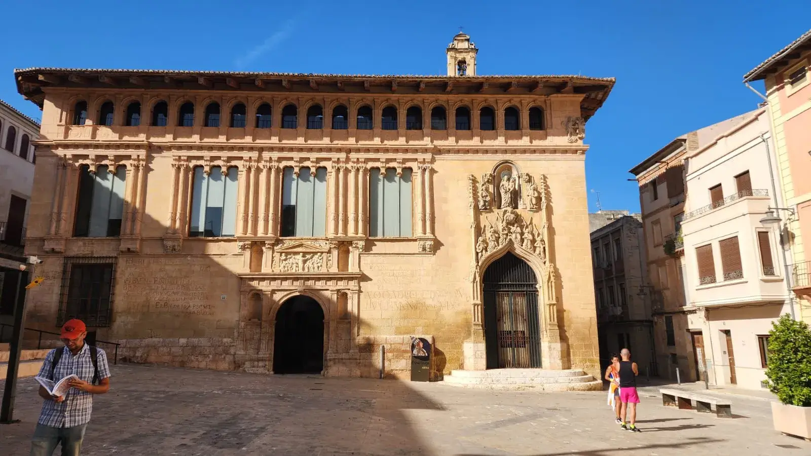 Gothic palace facade on a sunlit square in Xàtiva
